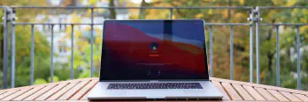 Laptop on table with blured garden view